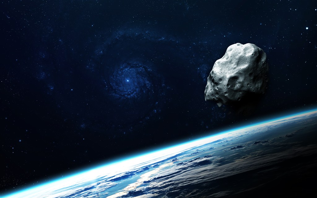 宇宙中的星球表面和漂浮的陨石高清图片