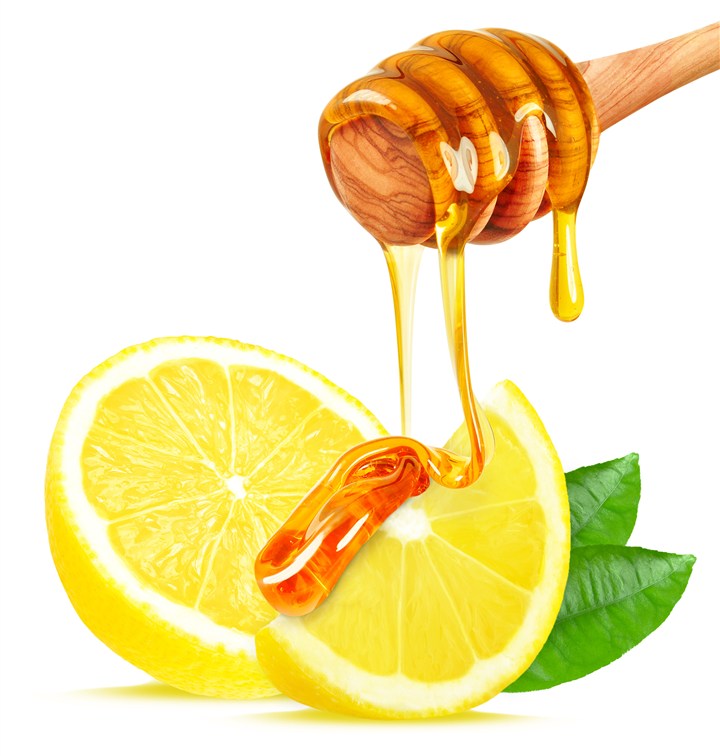 滴落在柠檬上的蜂蜜高清图片